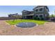 Spacious backyard featuring a trampoline, swing set, lush lawn and covered patio perfect for outdoor entertaining at 21341 S 227Th Way, Queen Creek, AZ 85142