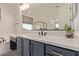 Modern bathroom features a vanity with quartz countertop, framed mirror, and sleek fixtures at 21341 S 227Th Way, Queen Creek, AZ 85142