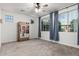Neutral bedroom with a ceiling fan and large windows overlooking the outdoors, complemented by blue curtains at 21341 S 227Th Way, Queen Creek, AZ 85142