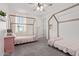Bright bedroom with two beds, ceiling fan, and natural light at 21341 S 227Th Way, Queen Creek, AZ 85142