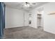 Bright bedroom with walk-in closet, featuring a ceiling fan, neutral walls, and carpet flooring at 21341 S 227Th Way, Queen Creek, AZ 85142