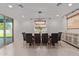Bright dining room with modern chandelier and sliding glass door at 21341 S 227Th Way, Queen Creek, AZ 85142