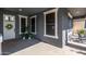 Covered entryway with dark gray exterior walls, plants, and a decorative front door at 21341 S 227Th Way, Queen Creek, AZ 85142