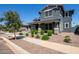 Charming two-story home with stone accents and lush landscaping creating an appealing exterior at 21341 S 227Th Way, Queen Creek, AZ 85142