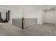 Upstairs hallway with carpet, iron railing, and stylish light fixture at 21341 S 227Th Way, Queen Creek, AZ 85142