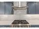 A detailed view of the kitchen highlights the gas range and subway tile backsplash at 21341 S 227Th Way, Queen Creek, AZ 85142