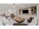 Spacious living room with built-in shelving and cabinetry, ceiling fan, and comfortable seating at 21341 S 227Th Way, Queen Creek, AZ 85142