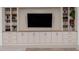 Living room boasts custom built-ins, cabinets, and shelving, perfect for storage and decor at 21341 S 227Th Way, Queen Creek, AZ 85142