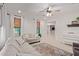 Bright living room with a ceiling fan, woven shades, and neutral furniture at 21341 S 227Th Way, Queen Creek, AZ 85142