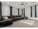 Spacious living room featuring a large sectional sofa and natural light at 21341 S 227Th Way, Queen Creek, AZ 85142