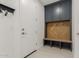 A functional mudroom features a built-in bench and storage cabinet at 21341 S 227Th Way, Queen Creek, AZ 85142