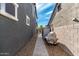 Narrow side yard with a brick walkway and a covered grill at 21341 S 227Th Way, Queen Creek, AZ 85142
