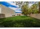 Expansive green backyard area with the garage in the background at 21615 E Pegasus Pkwy, Queen Creek, AZ 85142