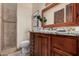 Bathroom with a brown vanity with a granite countertop and a separate shower at 21615 E Pegasus Pkwy, Queen Creek, AZ 85142