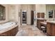 Bathroom featuring tub and access to a huge walk in closet with ample storage at 21615 E Pegasus Pkwy, Queen Creek, AZ 85142