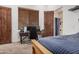Bedroom featuring a platform bed, gaming desk, and en-suite bathroom at 21615 E Pegasus Pkwy, Queen Creek, AZ 85142