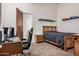 Bedroom featuring a platform bed, gaming desk and wall-mounted car displays at 21615 E Pegasus Pkwy, Queen Creek, AZ 85142