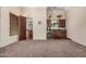 Spacious bonus room featuring a wet bar with cabinetry, a mini-fridge, and a powder room at 21615 E Pegasus Pkwy, Queen Creek, AZ 85142