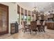 Charming dining room featuring travertine flooring, a chandelier, and a bay window for a bright, inviting space at 21615 E Pegasus Pkwy, Queen Creek, AZ 85142