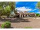 Stunning single-story home features elegant columns and a meticulously landscaped front yard at 21615 E Pegasus Pkwy, Queen Creek, AZ 85142