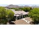 An exterior elevation showing a single-story home with a tile roof, charming facade, and desert landscaping at 21615 E Pegasus Pkwy, Queen Creek, AZ 85142