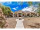 Stunning front exterior showcasing a well-maintained lawn, desert landscaping, and a water fountain at 21615 E Pegasus Pkwy, Queen Creek, AZ 85142