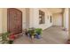Welcoming front porch featuring a beautiful wood door and charming decor elements at 21615 E Pegasus Pkwy, Queen Creek, AZ 85142
