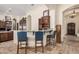 Stylish kitchen with bar seating, granite countertops, and adjacent dining area at 21615 E Pegasus Pkwy, Queen Creek, AZ 85142