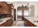 Gourmet kitchen with granite counters, stainless steel appliances and dark wood cabinets at 21615 E Pegasus Pkwy, Queen Creek, AZ 85142