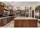 Spacious kitchen boasts granite counters, a large island, stainless appliances, and custom wood cabinetry at 21615 E Pegasus Pkwy, Queen Creek, AZ 85142