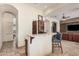 Modern kitchen area with bar seating and seamless connection to living spaces at 21615 E Pegasus Pkwy, Queen Creek, AZ 85142