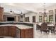 Open concept living space showcasing seamless flow from kitchen to dining, fireplace, and seating at 21615 E Pegasus Pkwy, Queen Creek, AZ 85142
