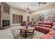 Inviting living room featuring a brick fireplace, comfortable seating, and natural light at 21615 E Pegasus Pkwy, Queen Creek, AZ 85142