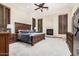 The main bedroom has an elaborate wood bed frame, gas fireplace and plantation shutters at 21615 E Pegasus Pkwy, Queen Creek, AZ 85142