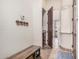 Mud room with bench seating, built-in shelving and access to the laundry room at 21615 E Pegasus Pkwy, Queen Creek, AZ 85142