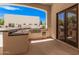 Outdoor kitchen with a grill, sink, and granite countertop on the back patio at 21615 E Pegasus Pkwy, Queen Creek, AZ 85142