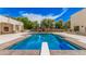 Private pool with diving board, surrounded by patio and lush landscaping at 21615 E Pegasus Pkwy, Queen Creek, AZ 85142