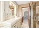 Bright bathroom with white cabinets, tile flooring, and a glass-door shower adjacent to the vanity at 2239 S Cottonwood --, Mesa, AZ 85202