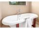 Freestanding bathtub next to an arched window with tile flooring and an elegant faucet at 2239 S Cottonwood --, Mesa, AZ 85202
