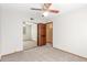 Bedroom with sliding closet doors, neutral walls, carpet, and an adjacent room at 2239 S Cottonwood --, Mesa, AZ 85202