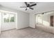 Neutral bedroom featuring plush carpet, a ceiling fan, a window and mirrored closet at 2239 S Cottonwood --, Mesa, AZ 85202