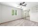 Bright bedroom featuring neutral walls, carpet, a ceiling fan, and a mirrored closet at 2239 S Cottonwood --, Mesa, AZ 85202
