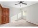 Bedroom featuring neutral walls, carpet, ceiling fan, and a dark brown solid door at 2239 S Cottonwood --, Mesa, AZ 85202