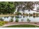 Serene lake with a fountain, surrounded by trees and well-maintained landscaping at 2239 S Cottonwood --, Mesa, AZ 85202