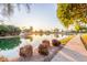 Tranquil community pond view with lush greenery and waterfront homes, creating a peaceful and attractive setting at 2239 S Cottonwood --, Mesa, AZ 85202