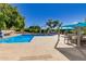 Attractive community pool area with lounge chairs, shaded seating, and well-maintained landscaping at 2239 S Cottonwood --, Mesa, AZ 85202