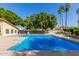 Large community pool with shallow and deep ends, surrounded by lush landscaping and privacy walls at 2239 S Cottonwood --, Mesa, AZ 85202