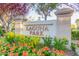 Landscaped Laguna Park community sign framed by mature trees and colorful flower beds at 2239 S Cottonwood --, Mesa, AZ 85202