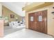 Inviting entryway featuring double wood doors with glass inserts and a spacious, light-filled living area at 2239 S Cottonwood --, Mesa, AZ 85202
