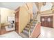 Hallway features a carpeted staircase and entryway door leading to a large dining area and entryway at 2239 S Cottonwood --, Mesa, AZ 85202